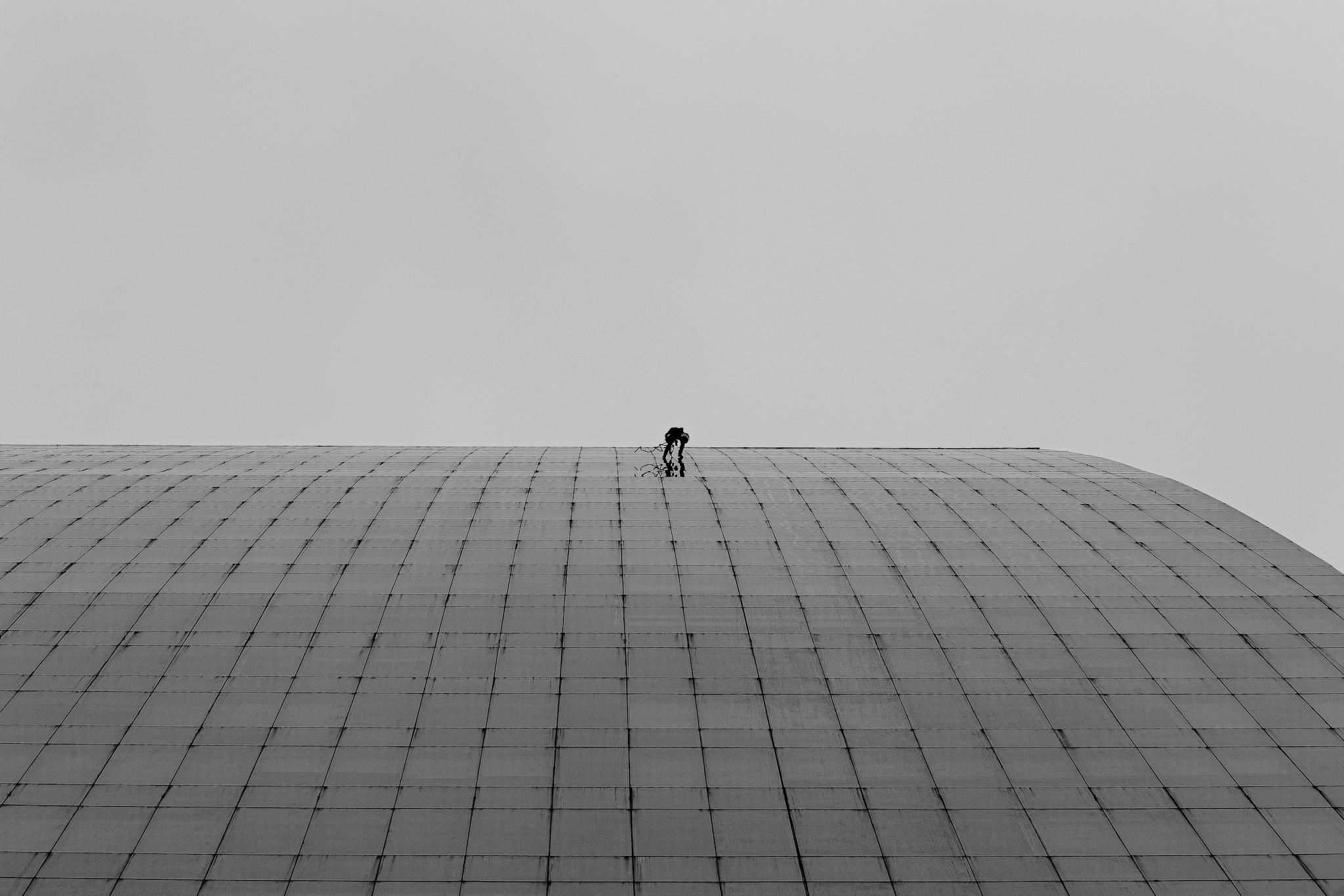 Limpador de faachadas escalando edifício.